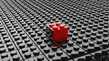 Black Lego Background With One Red Block Standing Out