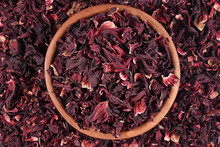 Dried Petals Of Hibiscus In A Wooden Bowl