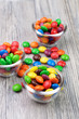 Three tiny bowls with crunchy color candies