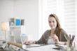 © jackfrog - beautiful young woman working on her laptop in her office