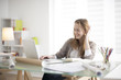 © jackfrog - beautiful young woman sitting at her desk in the workplace