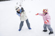 © TAGSTOCK2 - parents and child having snowball fight