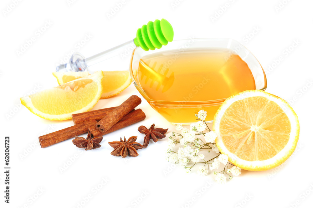 Sweet honey with lemon and cinnamon isolated on white
