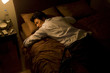 © TAGSTOCK2 - businessman sleeping on bed with suit worn