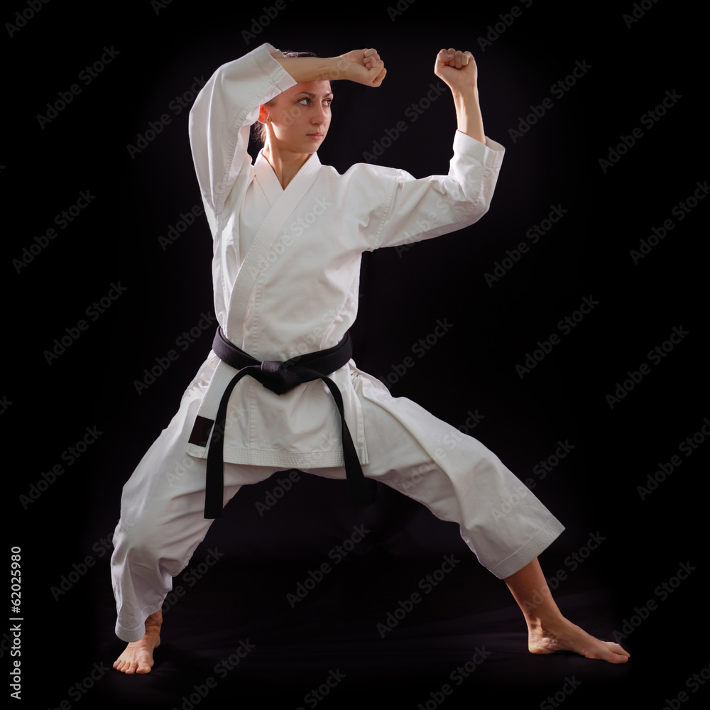 karate girl with black belt posing, champion of the world, on bl