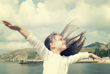 Wall Mural - child enjoying fresh summer wind