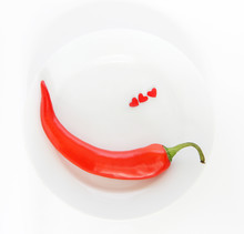 Red Chili Pepper On A White Plate Wiith Little Hearts Shapes