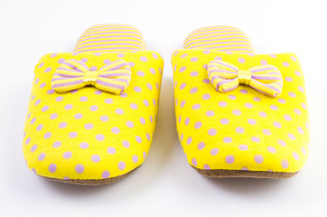 Yellow house slippers isolated on white background