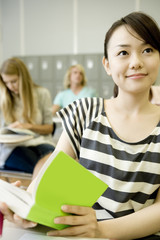 Wall Mural - female student studying in classroom