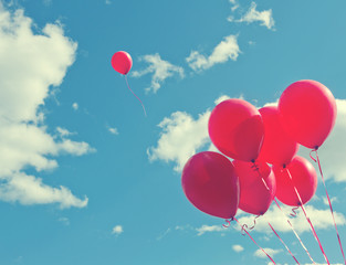 bunch of red ballons on a blue sky