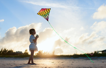 Wall Mural - Little girl flying a kite