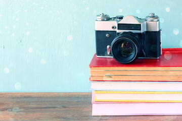 Vintage camera over stack of books