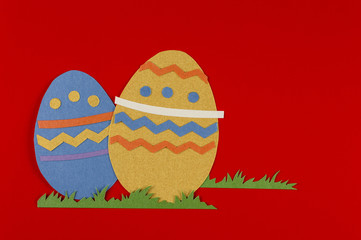 colorful eggs with grass on a red background