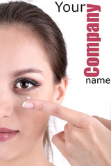 Wall Mural - Young woman putting contact lens in her eye close up