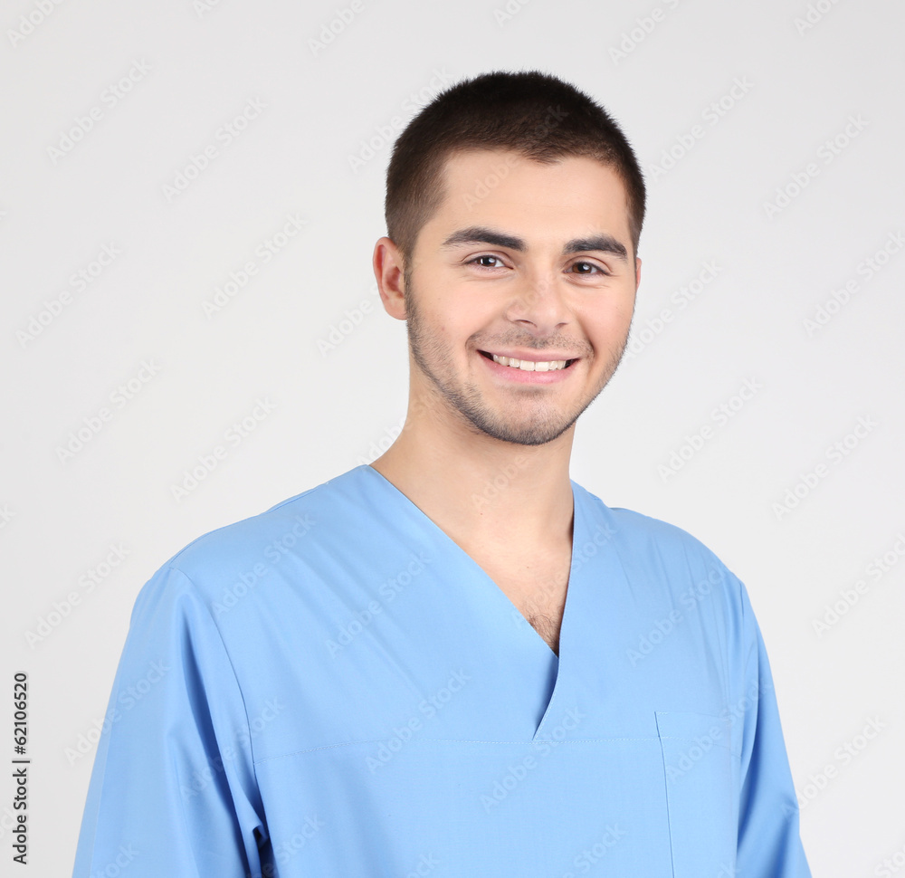 Young male doctor isolated on white