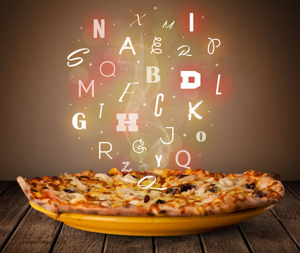 Fresh italian pizza with colorful letters on wood