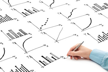 businessman drawing bar chart and other infographics in note pad