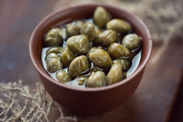 Wall Mural - Close-up of a ceramic pialat with marinated capers