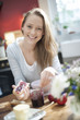 © jackfrog - cheerful young woman at breakfast in her kitchen