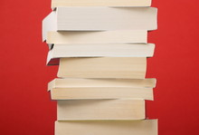Stack Of Paperback Books On A Red Background