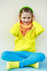 Wall Mural - Young girl enjoying music