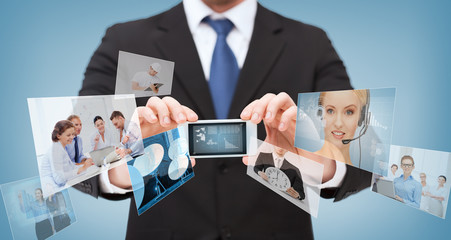 businessman with smartphone and news on screen