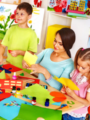 Children with teacher at classroom.