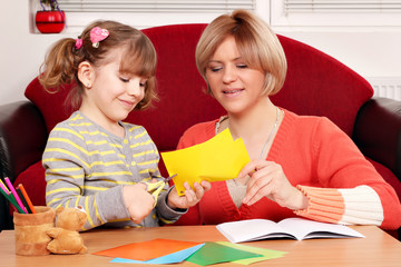 Wall Mural - happy mother and daughter cutting paper