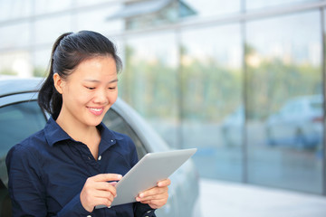 Wall Mural - young asian business woman use digital tablet