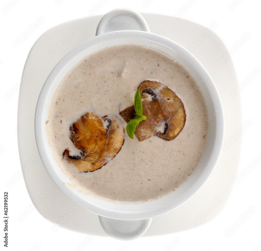 Mushroom soup in white bowl, on plate, isolated on white