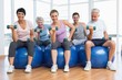 © WavebreakMediaMicro - Fitness class with dumbbells sitting on exercise balls