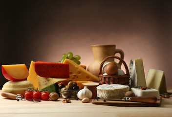 Wall Mural - Tasty dairy products on wooden table, on dark background