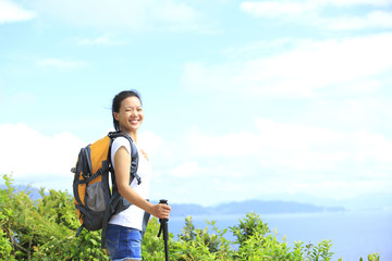 woman hiker enjoy the view at seaside mountain peak