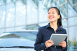 © lzf - young asian business woman use digital tablet beside her car