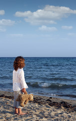 Wall Mural - little girl with teddy bear on beach summer season