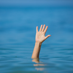 Wall Mural - hand of drowning man in sea asking for help