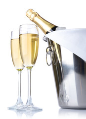 Wall Mural - Glasses of champagne and bottle in pail, isolated on white