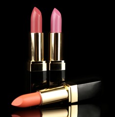 Beautiful lipsticks on black background