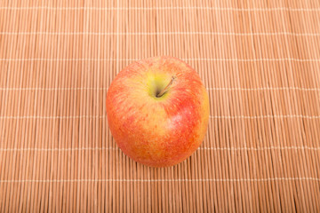 Wall Mural - Single Gala Apple on Bamboo Placemat