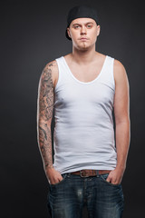 man standing with tattoo on hand and looking.