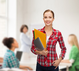 Canvas Print - smiling student with folders and tablet pc