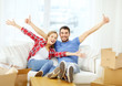 © Syda Productions - smiling couple relaxing on sofa in new home