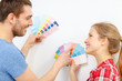© Syda Productions - smiling couple looking at color samples at home