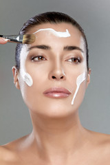 Wall Mural - beautiful spa girl with cream on her face. skincare concept