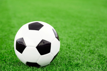 Traditional soccer ball on soccer field