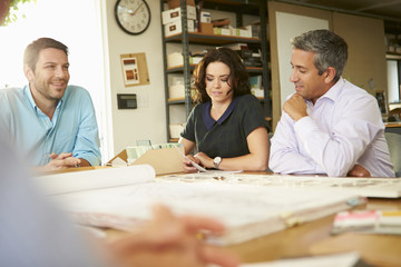 Sticker - Four Architects Sitting Around Table Having Meeting