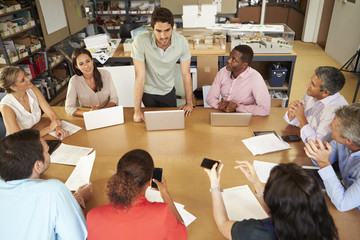 Poster - Architects Sitting At Table Meeting With Laptops And Tablets