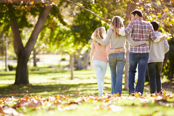 Canvas Print - Rear View Of Family Walking Through Autumn Woodland