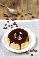 Wall Mural - Delicious donut with chocolate on wooden table