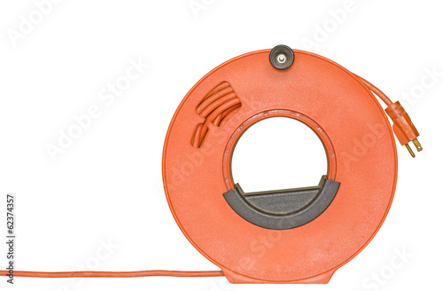 Fotografie, Obraz Power cord extension plug on orange plastic reel.
